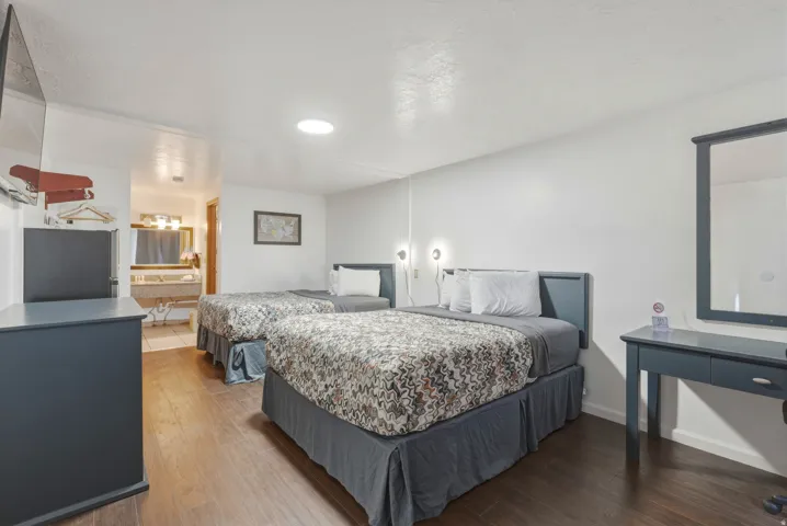 Bedroom featuring dark wood-finish flooring and white walls
