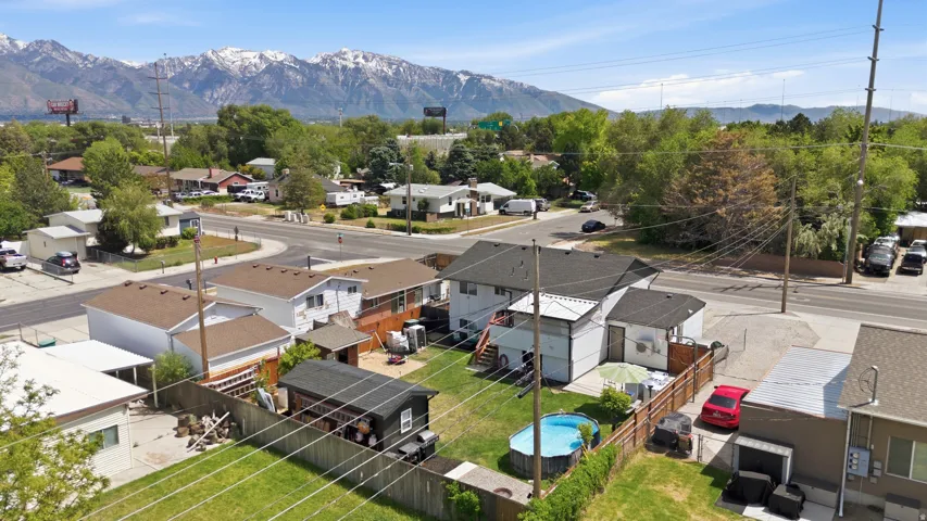Property featuring a fenced backyard with an above-ground pool, a detached shed, and a paved patio area