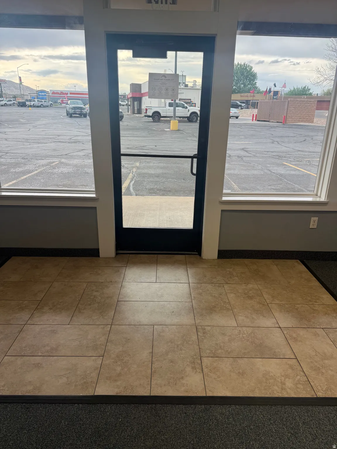 Commercial entry featuring a glass door and expansive windows