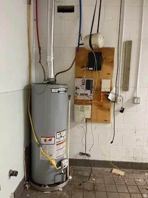 Water heater and utility wall with visible conduit