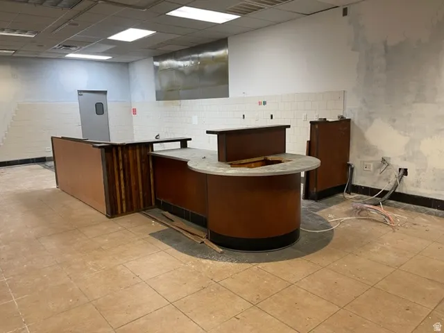 Commercial interior featuring a built-in service counter with wood-finish paneling and an integrated circular cutout