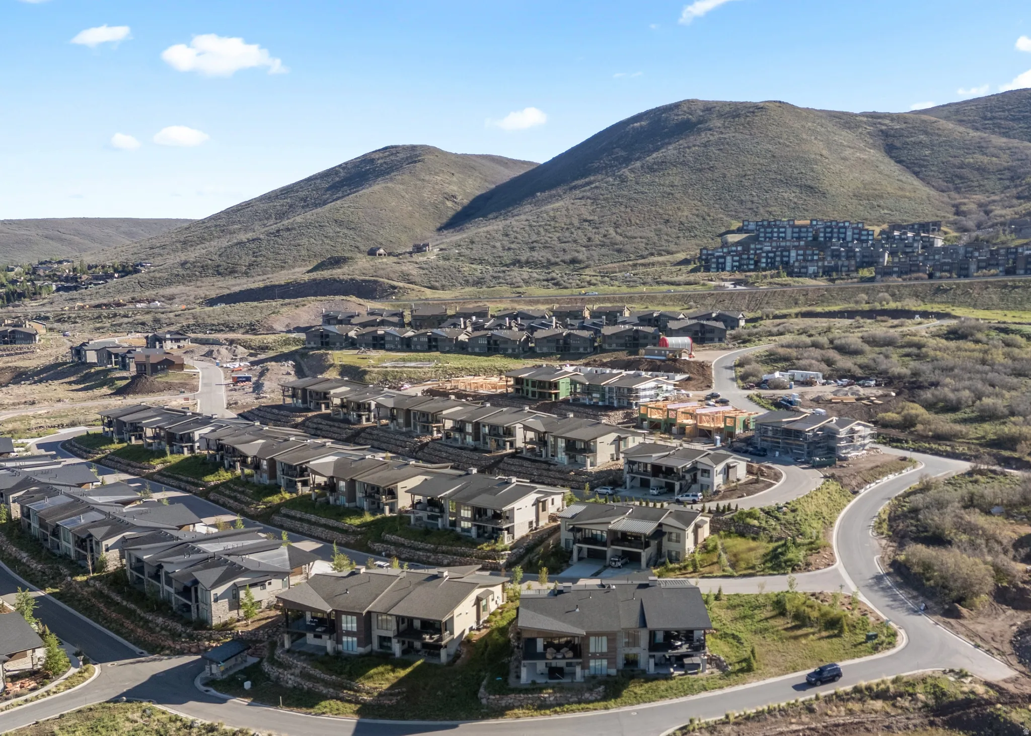 New construction residential development featuring multi-level residences with balconies and covered patios