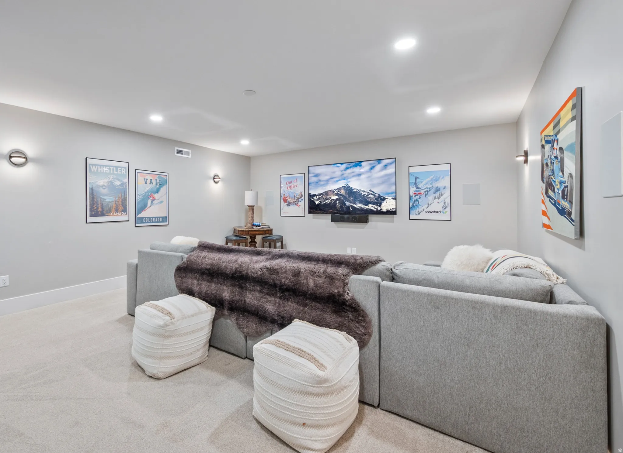Spacious media room featuring recessed lighting, light-toned carpeting, and a built-in media speaker system
