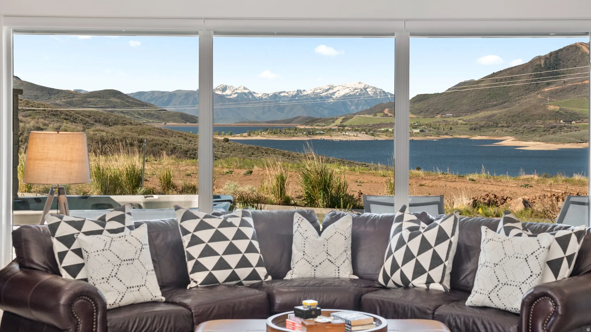 Expansive window wall with mountain and lake scenery