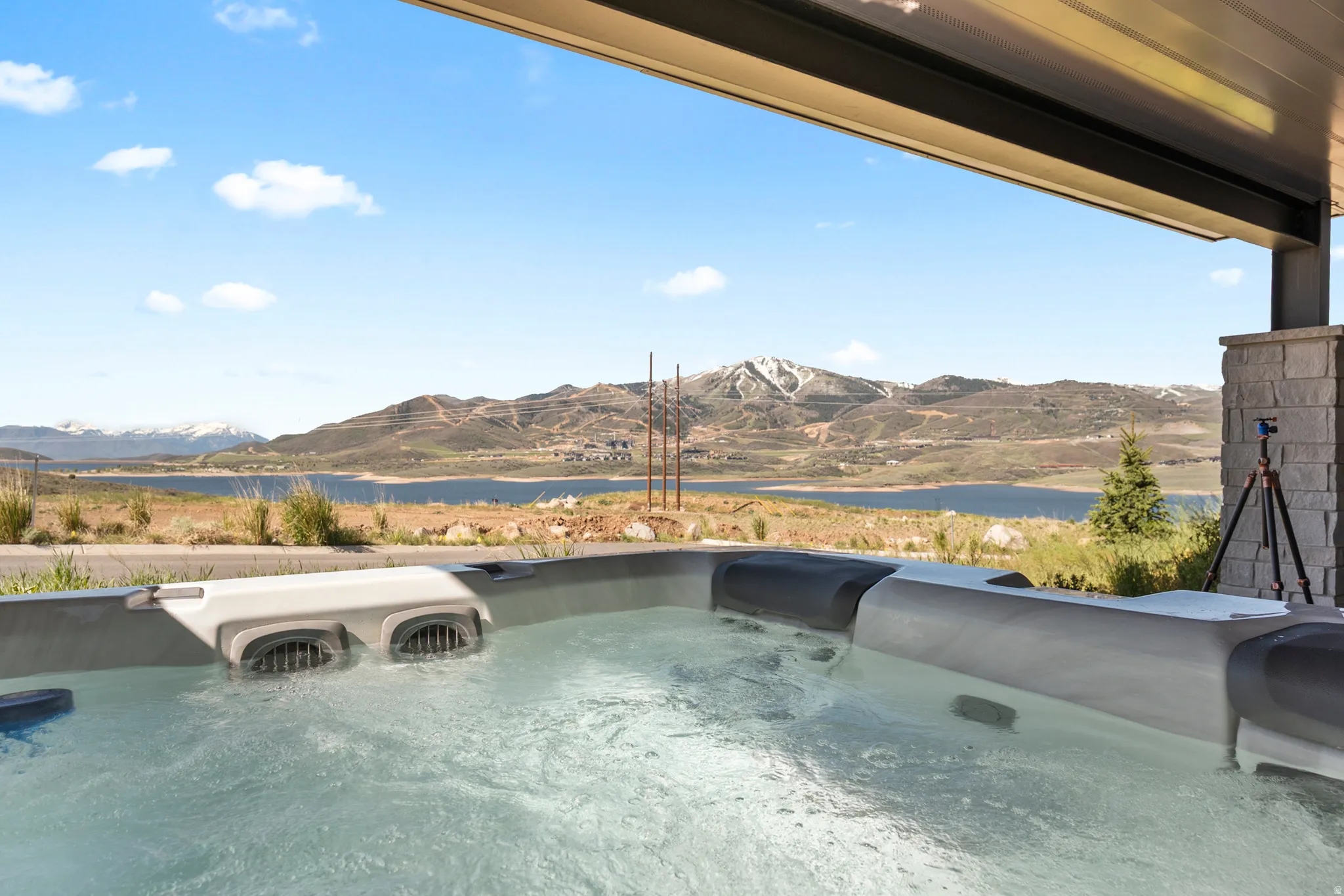Outdoor hot tub with mountain and lake scenery