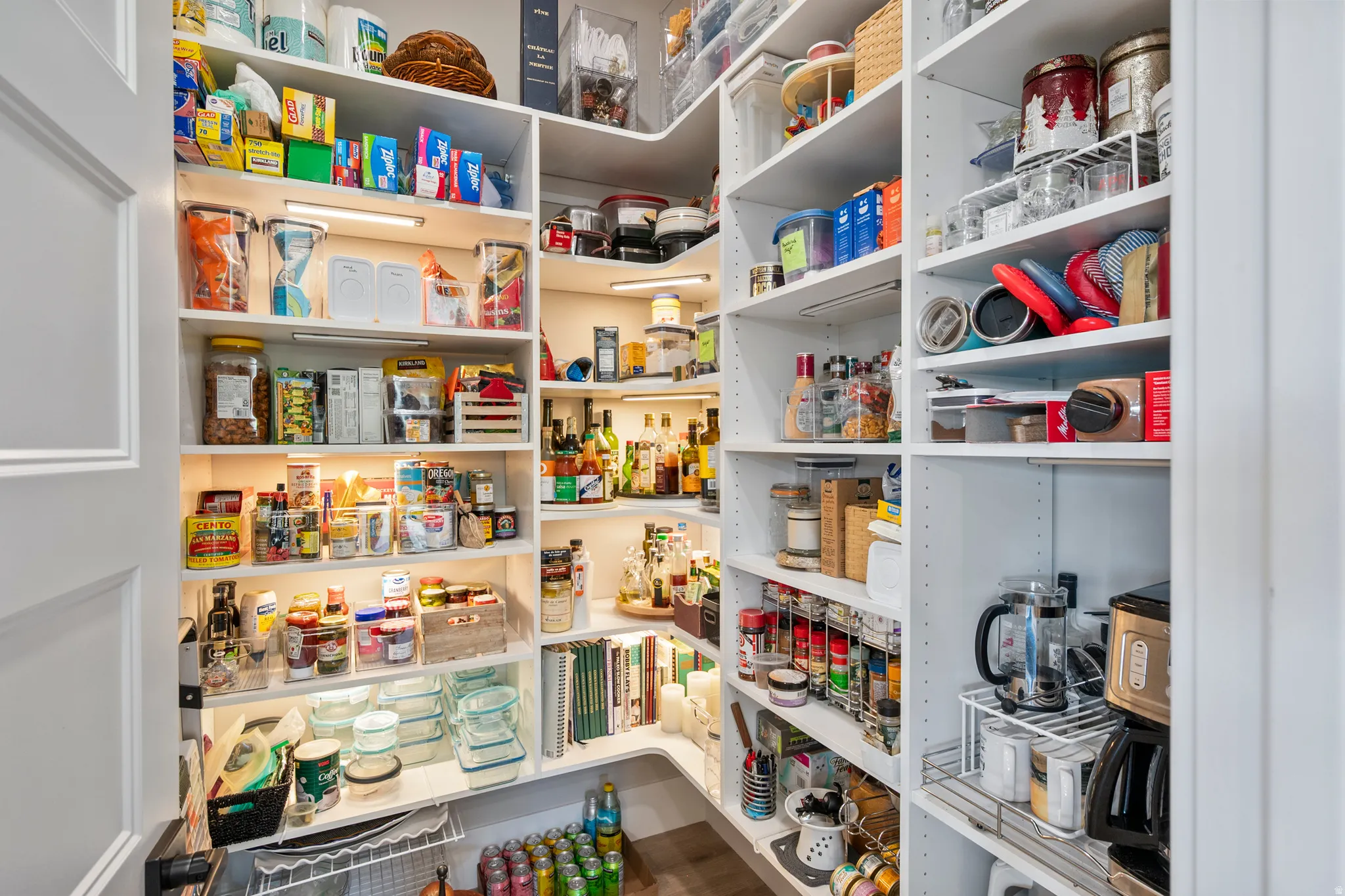 Custom-built pantry featuring extensive shelving, integrated under-shelf lighting, and pull-out wire storage solutions