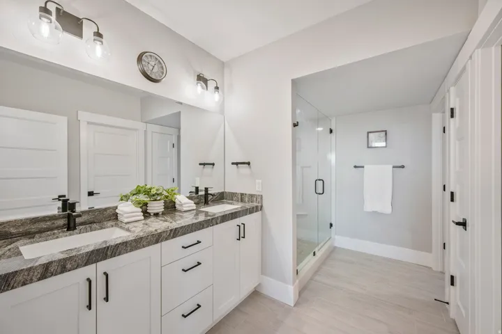 Dual vanity featuring integrated sinks and dark-toned countertops