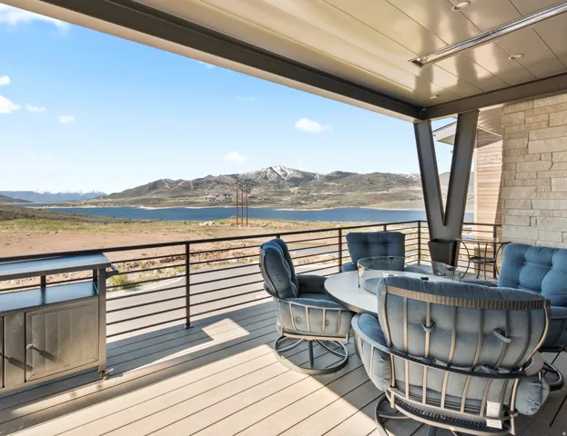 Spacious covered deck with composite decking and a black metal railing