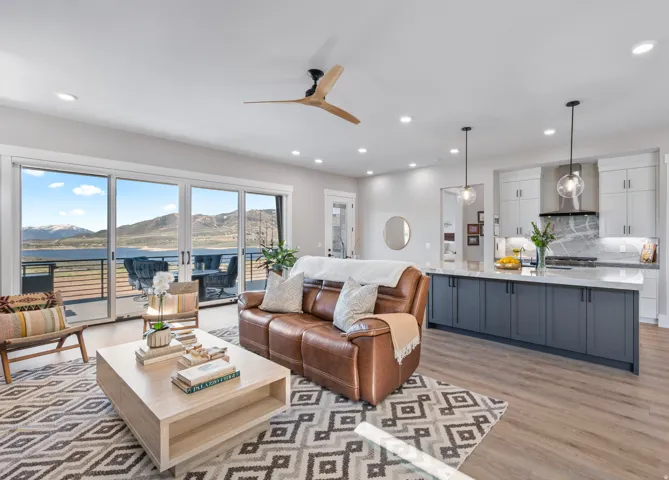 Open-concept living area featuring wood-finish flooring, recessed lighting, and a modern ceiling fan