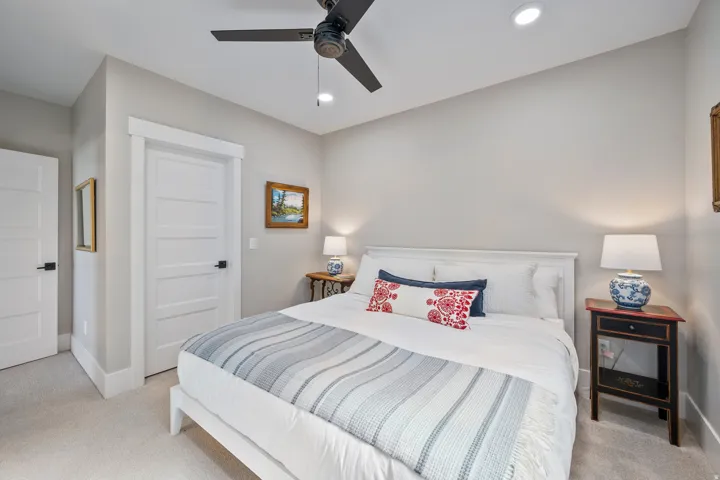 Bedroom featuring light gray walls, plush carpeting, a ceiling fan with integrated lighting, and recessed overhead lighting