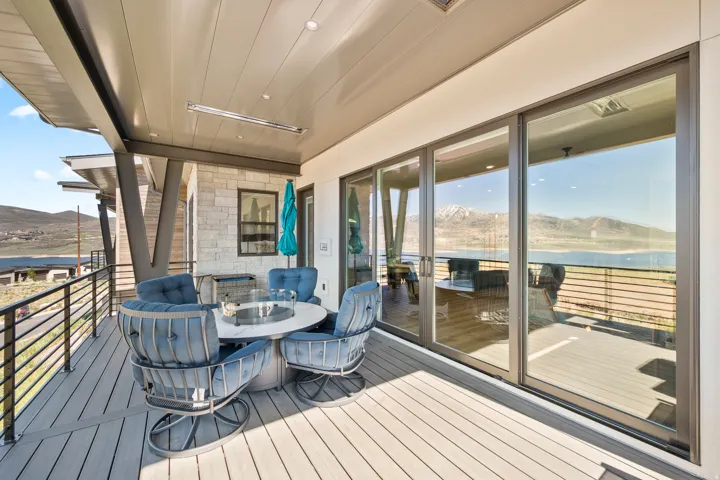 Spacious outdoor deck featuring composite decking, a metal railing system, and a built-in overhead heater