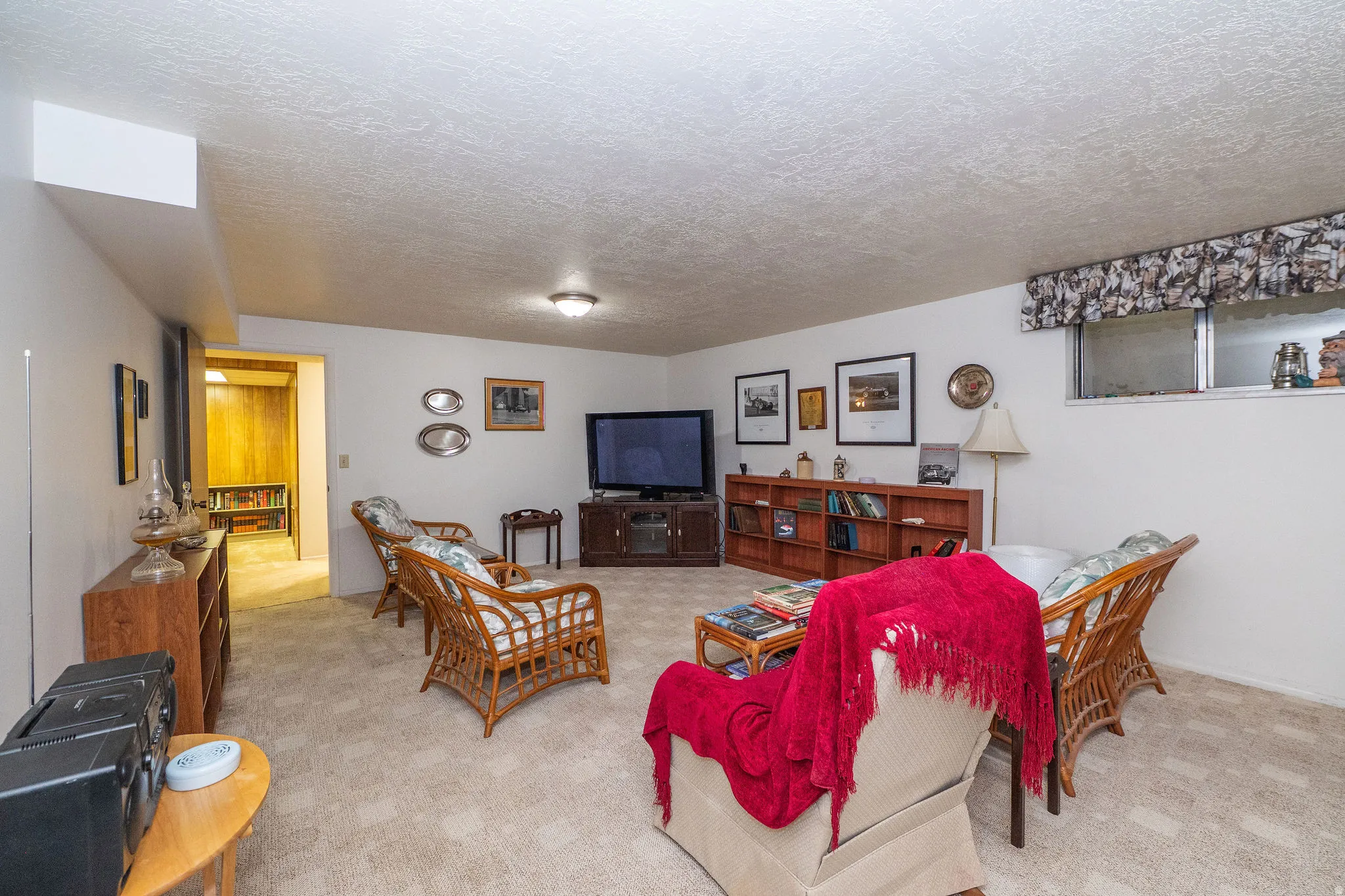 Spacious carpeted room featuring white walls and a textured ceiling