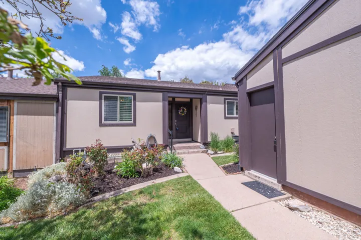 Neutral-toned exterior with dark trim accents and full landscaping.