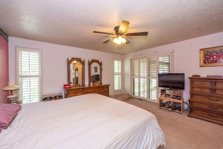 Sliding glass doors leading to covered patio. Louvered shutters on all windows.