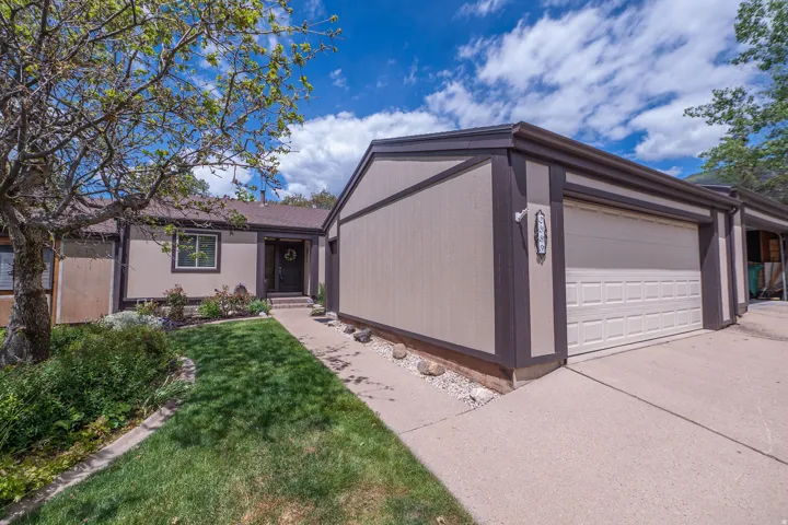South facing frong exterior featuring a two-car garage, concrete driveway, and front walkway