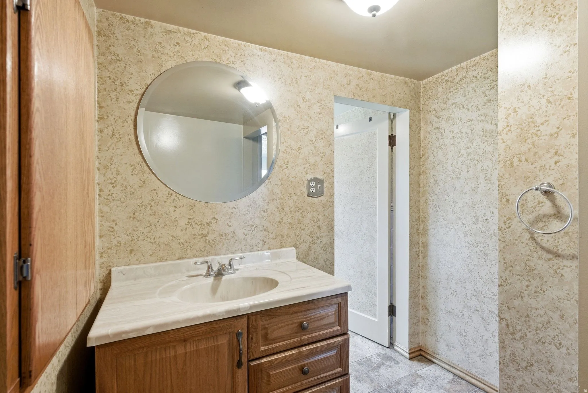 Vanity with an integrated sink and light-toned countertop