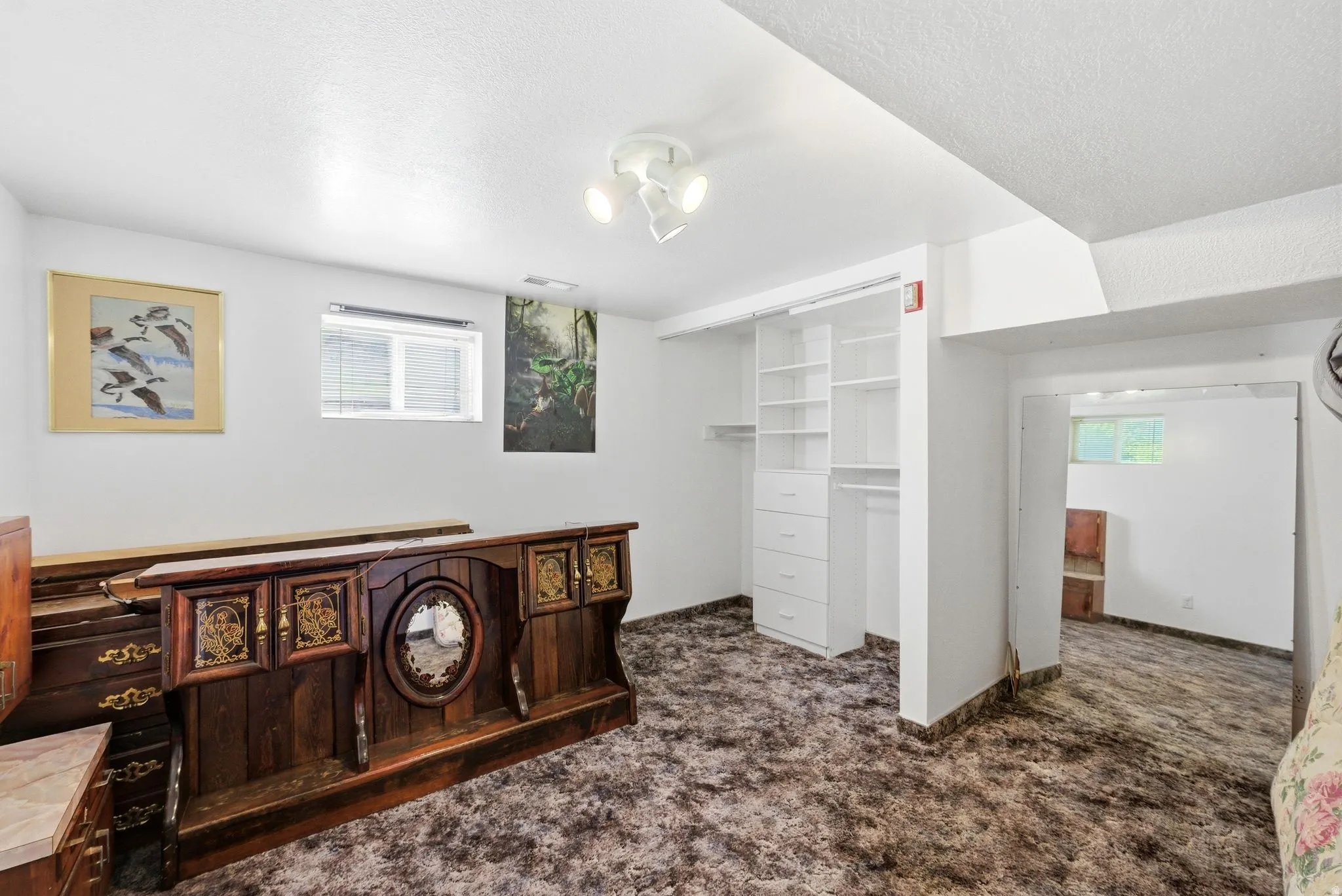 Room featuring wall-to-wall carpeting, recessed window, and white walls