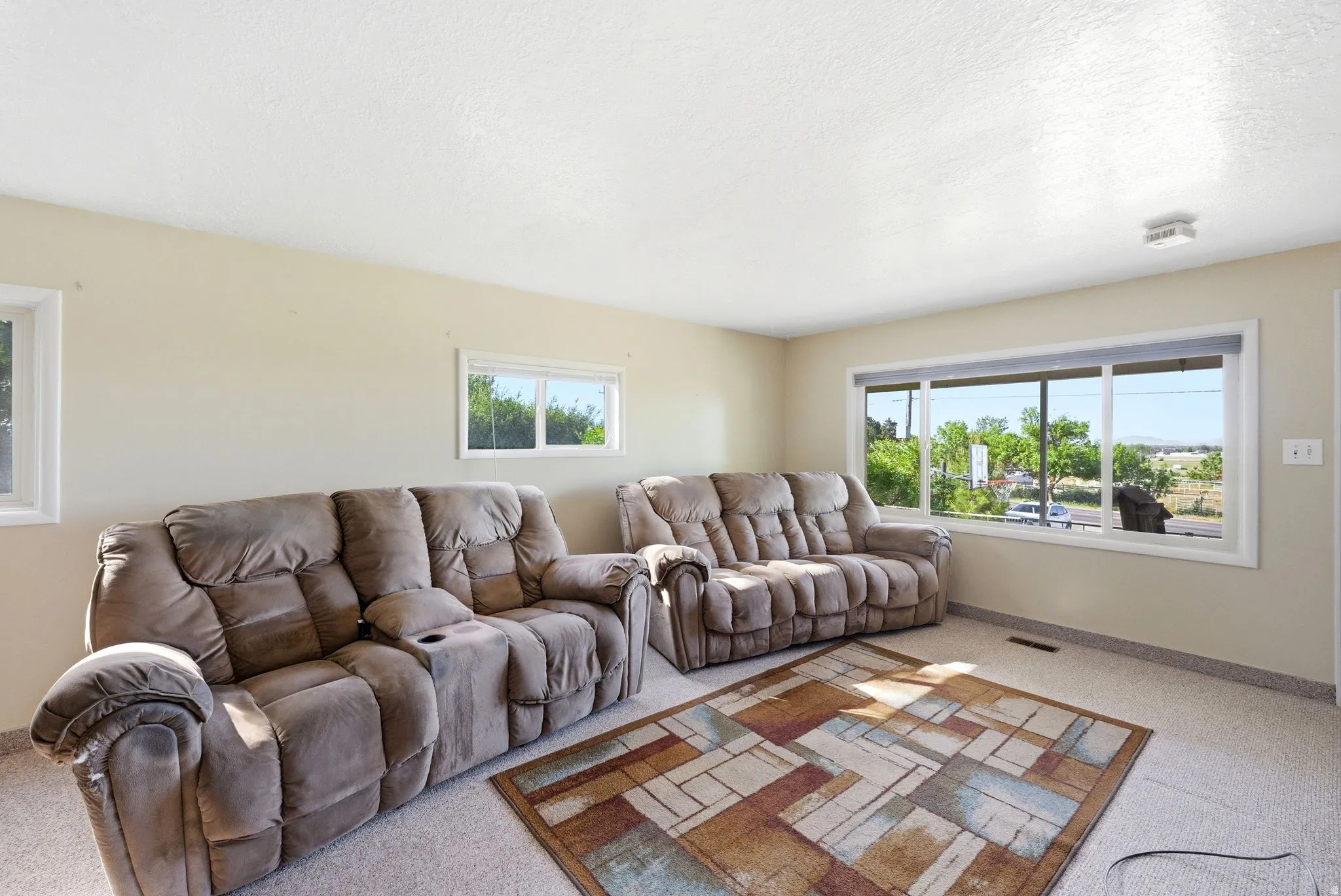 Bright room with neutral wall tones and textured ceiling