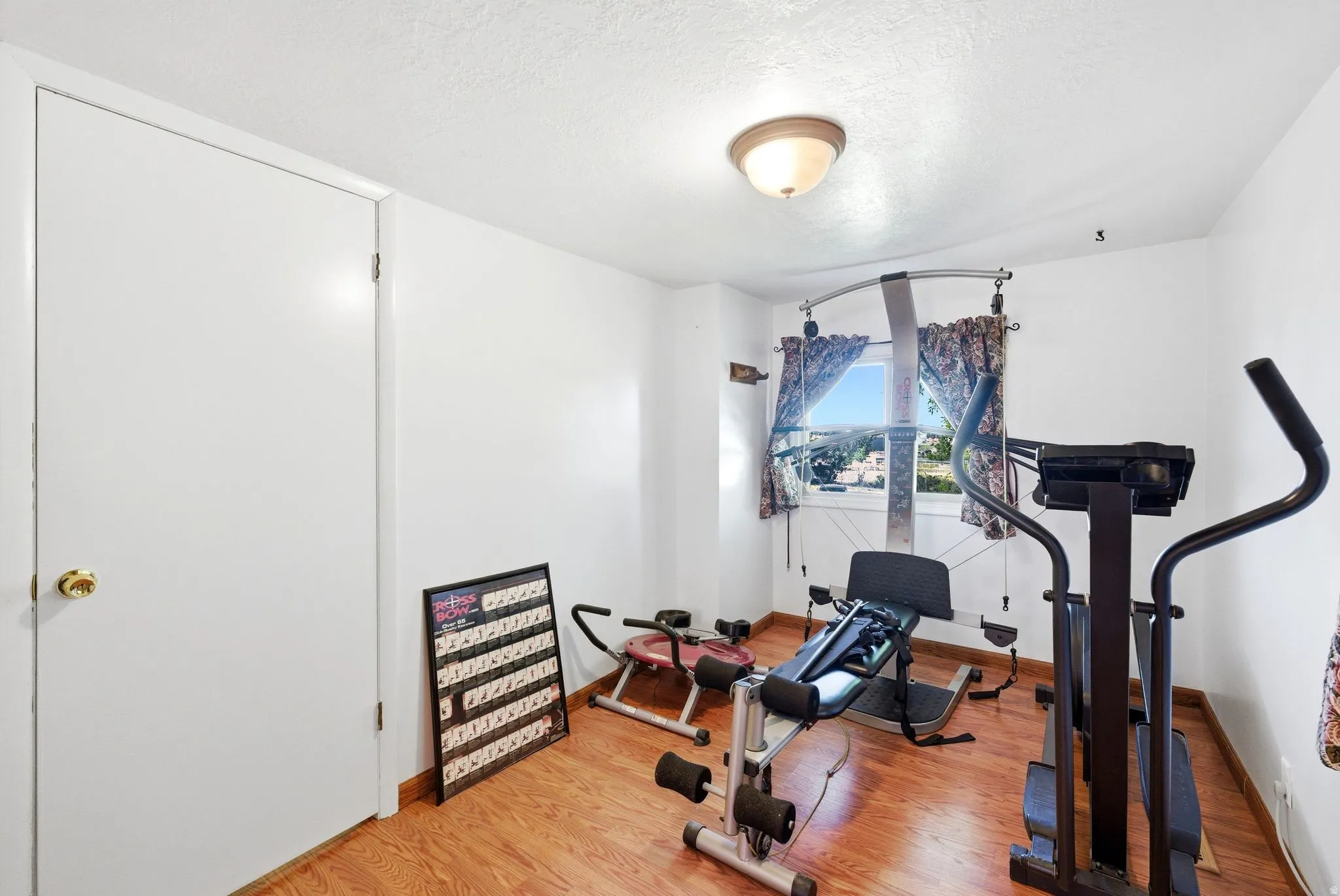 Bright room featuring wood-finish flooring and a single window