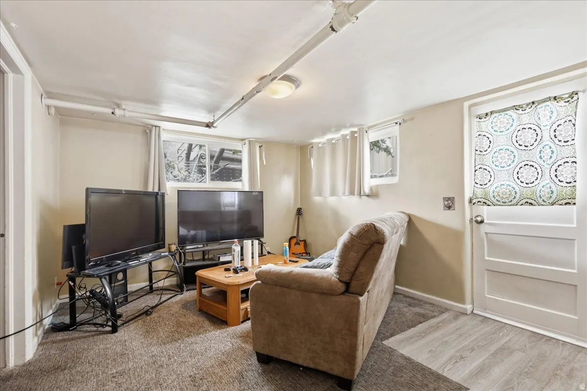 Finished lower level featuring carpeted and wood-finish flooring