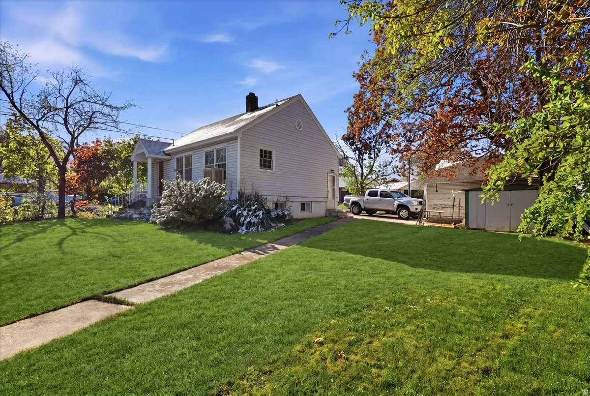 Exterior featuring a classic gabled roofline and light-colored siding
