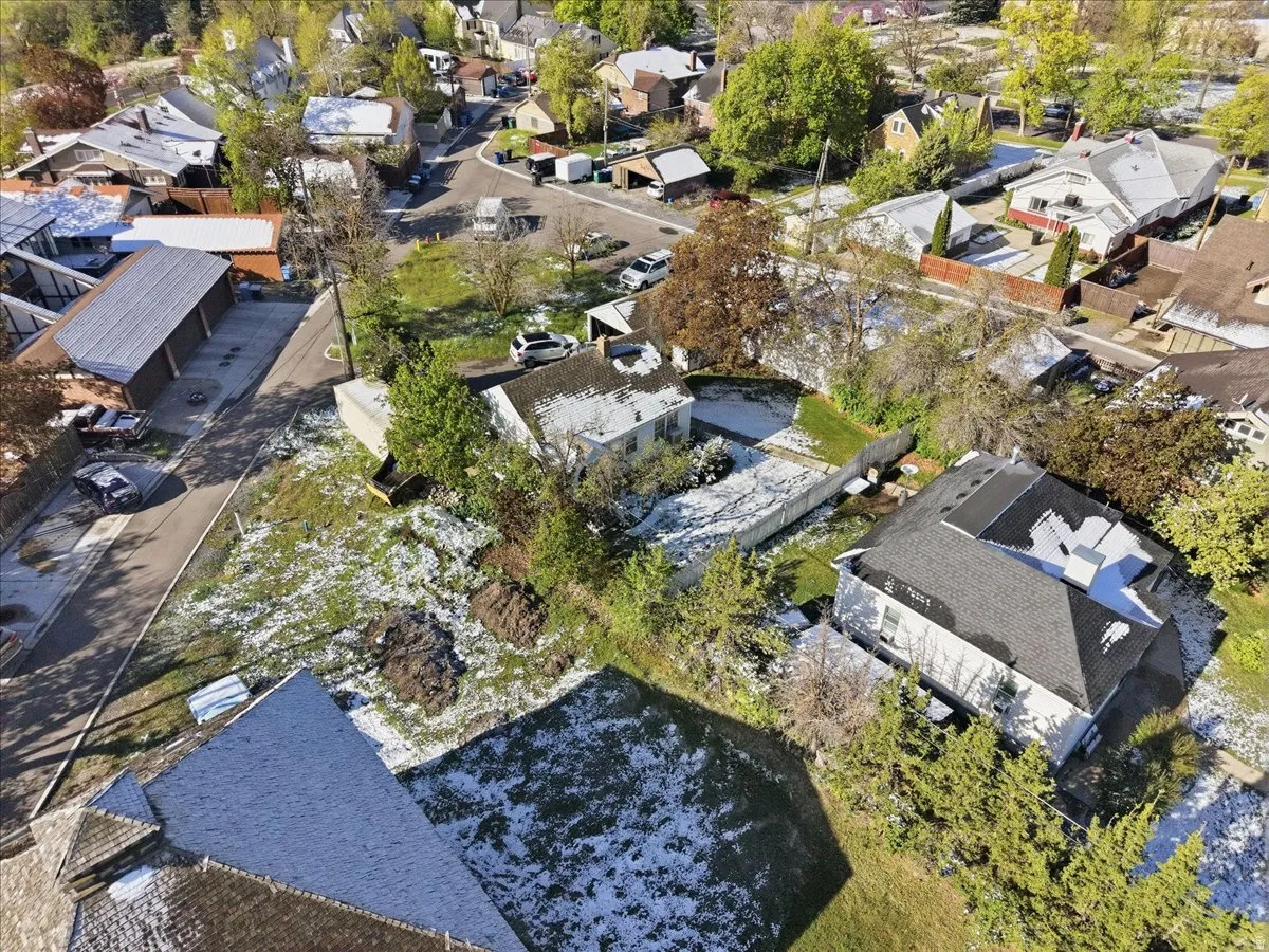 Aerial perspective showcasing residential properties with varied rooflines and surrounding green spaces