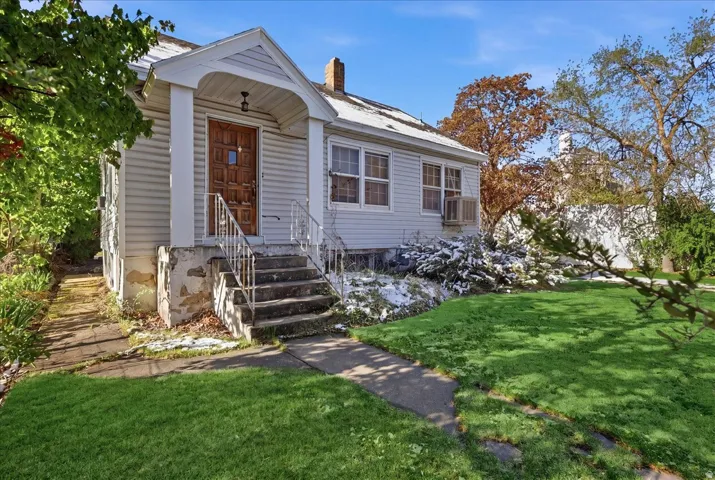 Light-colored siding exterior with an inviting covered porch entry