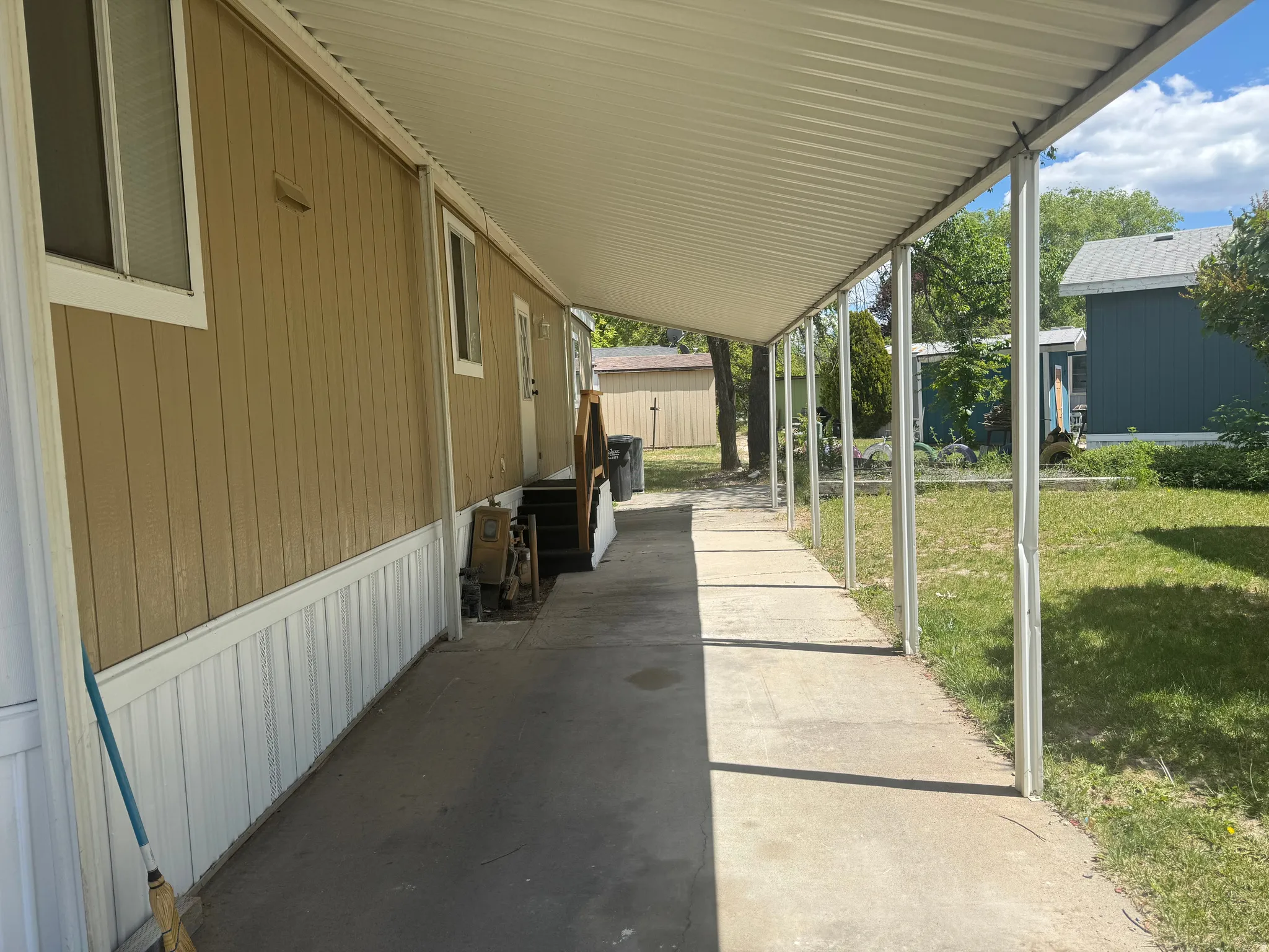 Covered concrete walkway alongside the building