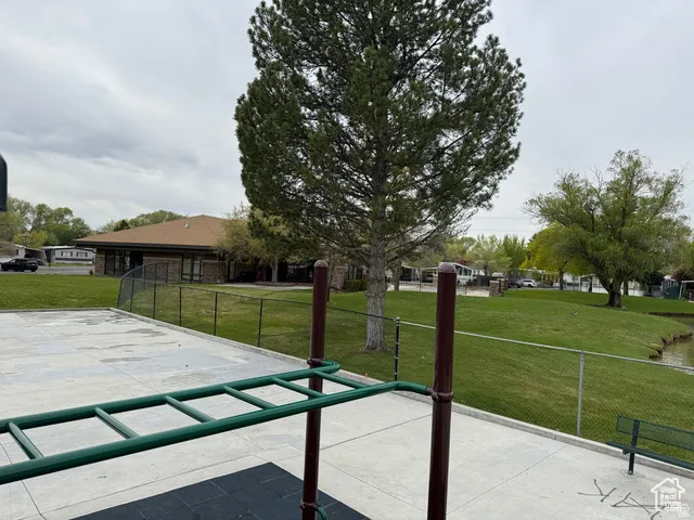 Concrete patio area featuring a monkey bar structure