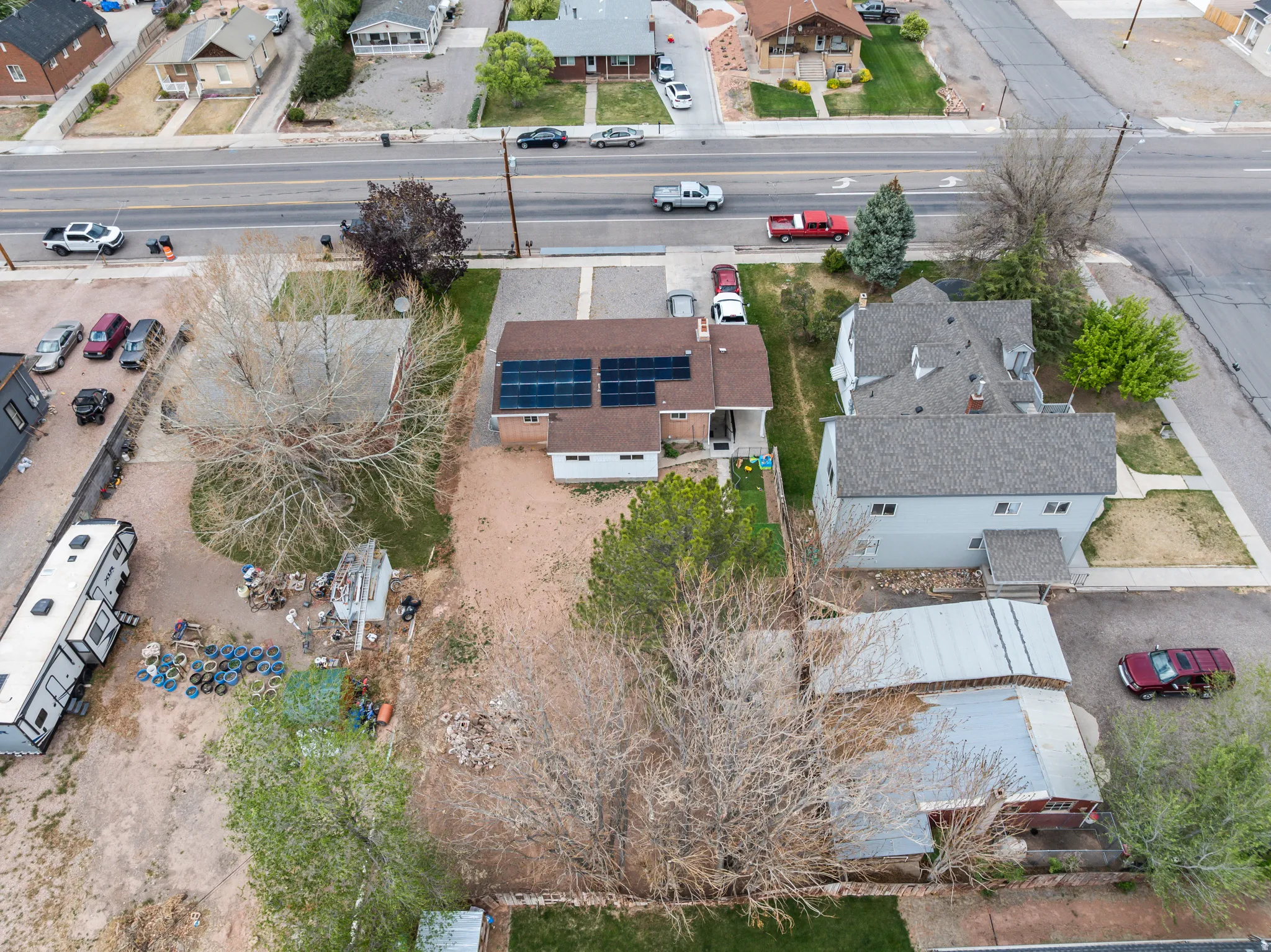 Residential property featuring a shingled roof and solar panels