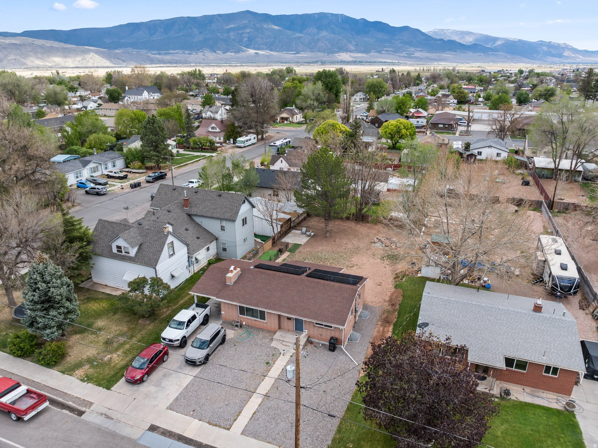 Aerial view showcasing a residential neighborhood with surrounding mountains