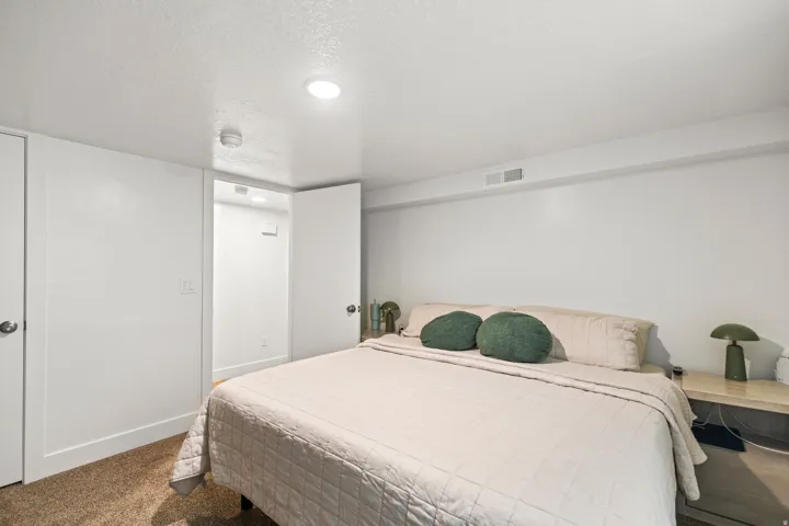 Bedroom featuring recessed lighting, a door with a chrome knob, and a doorway opening to an interior space