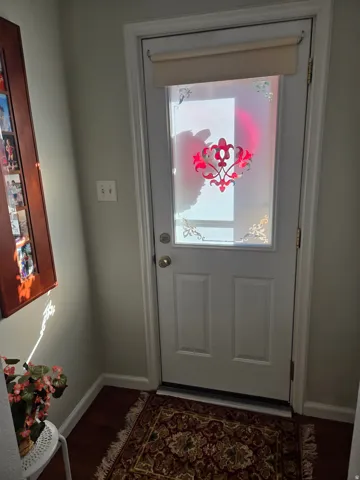 Entry door with decorative glass insert and privacy shade