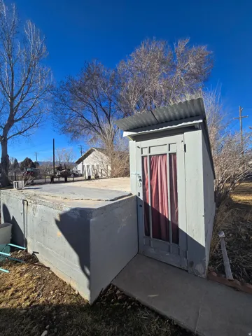 Freestanding utility shed with corrugated metal roof