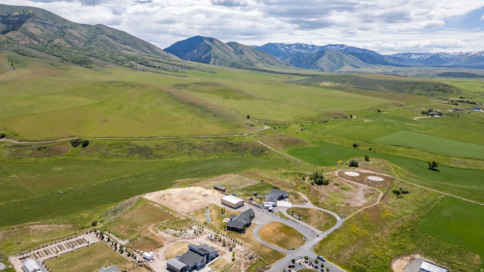Expansive rural landscape featuring lush green fields and distant mountains