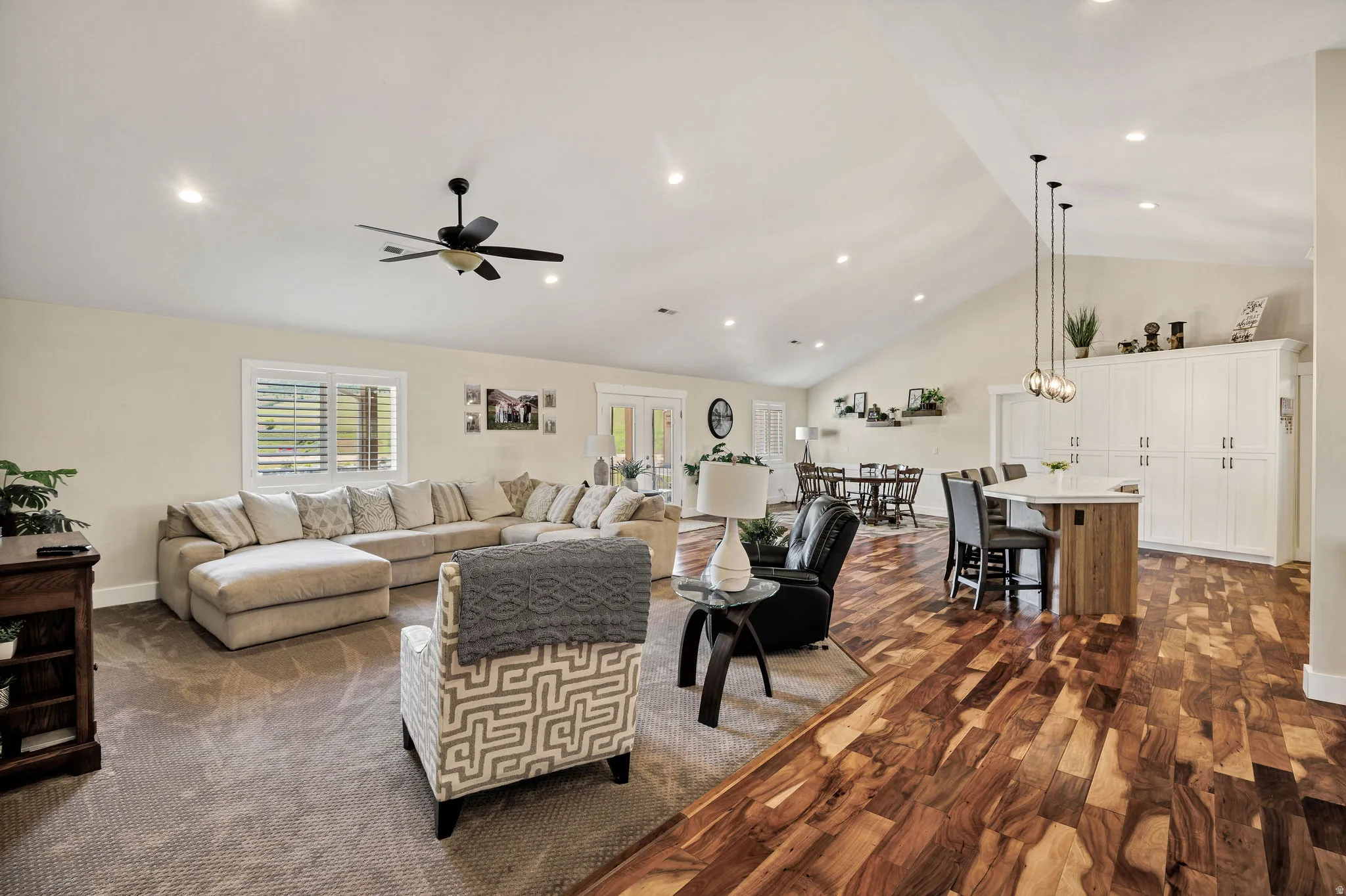 Spacious open-concept living area featuring a vaulted ceiling and recessed lighting