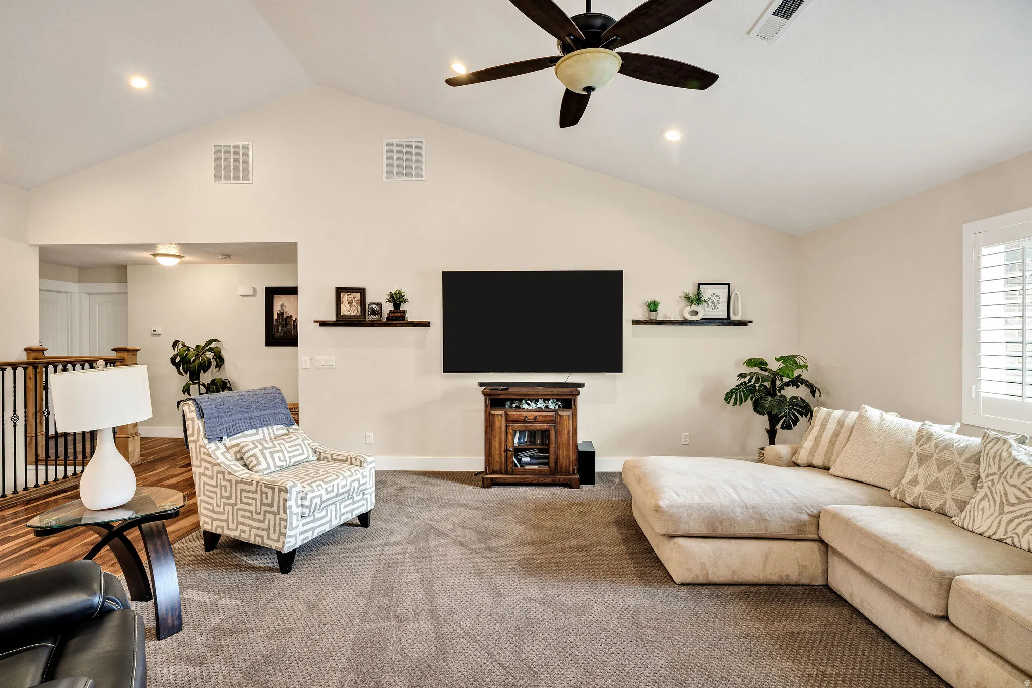Vaulted ceiling living area featuring recessed lighting and a ceiling fan
