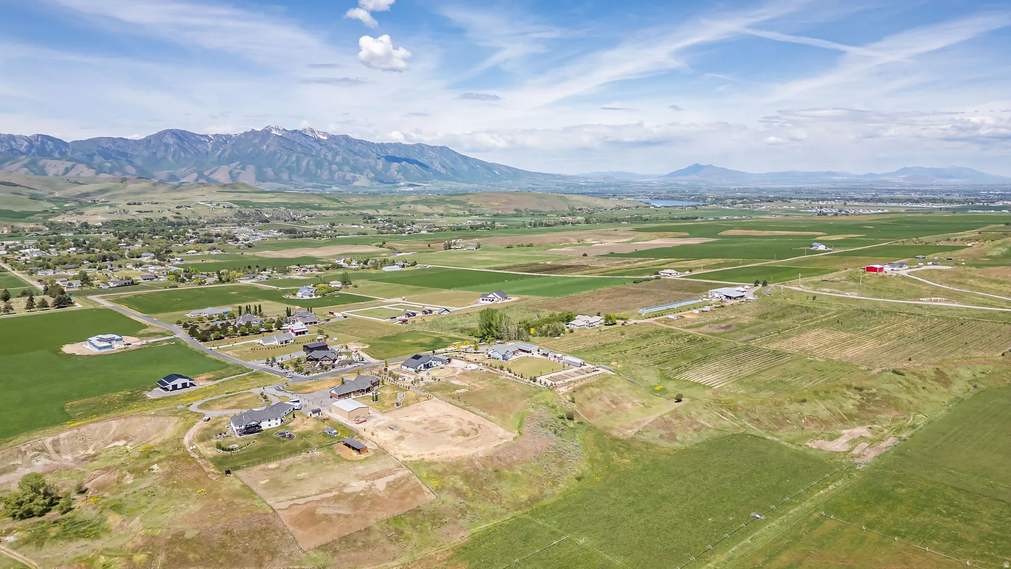 Expansive land parcel featuring open fields and distant mountain ranges