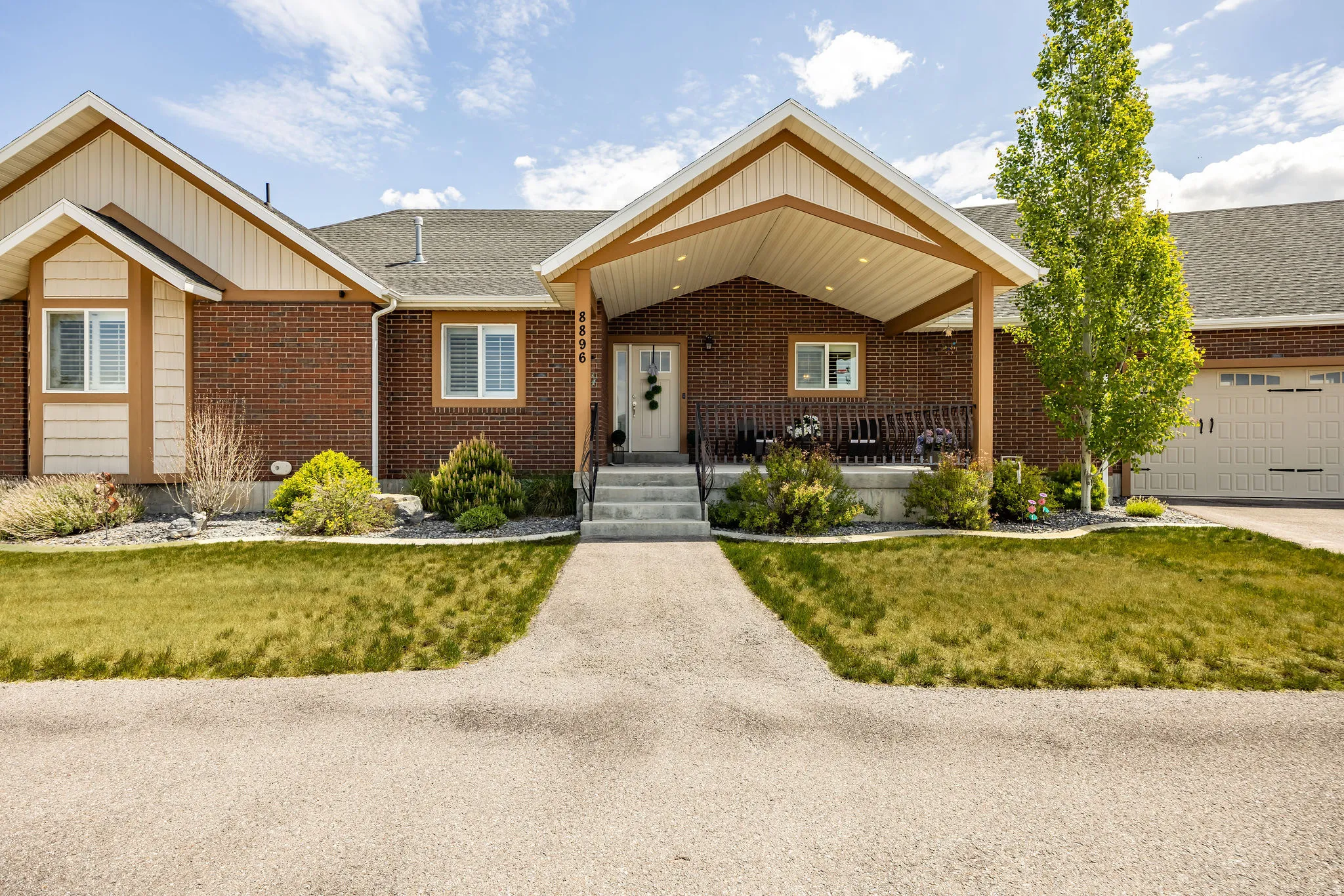 Brick facade with shingle roofing and complementary siding accents
