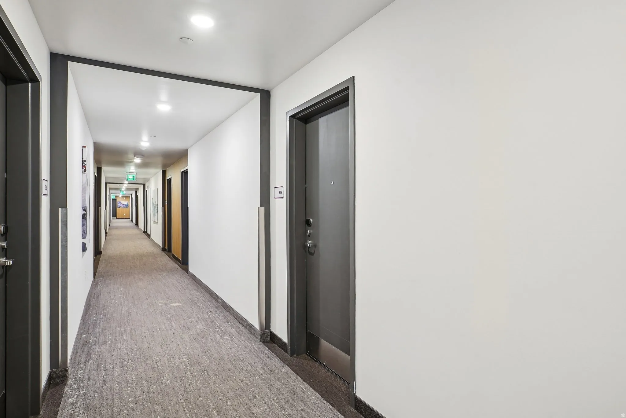 Building hallway featuring recessed lighting and wall-to-wall carpeting