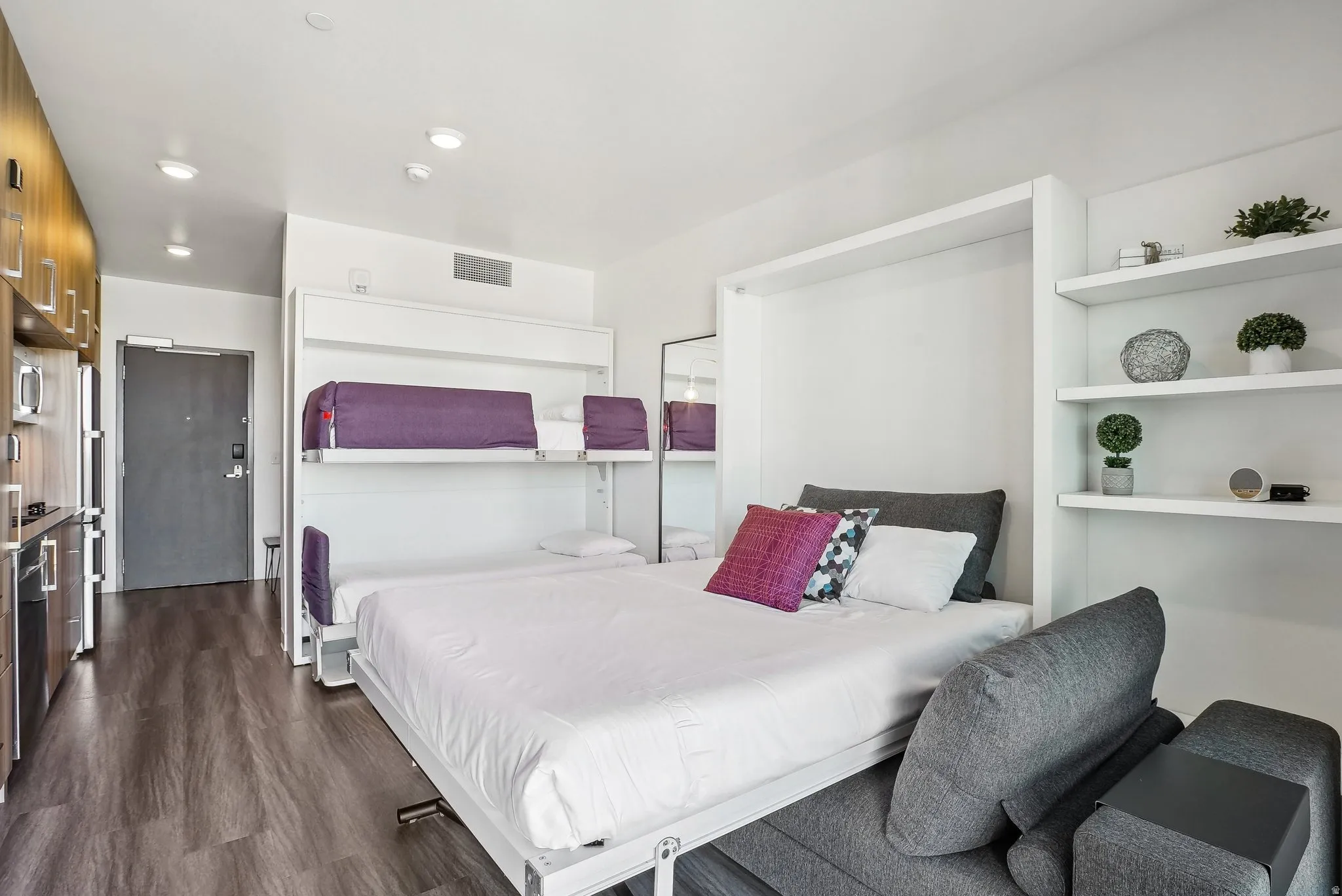 Compact living area featuring wood-finish flooring and recessed lighting