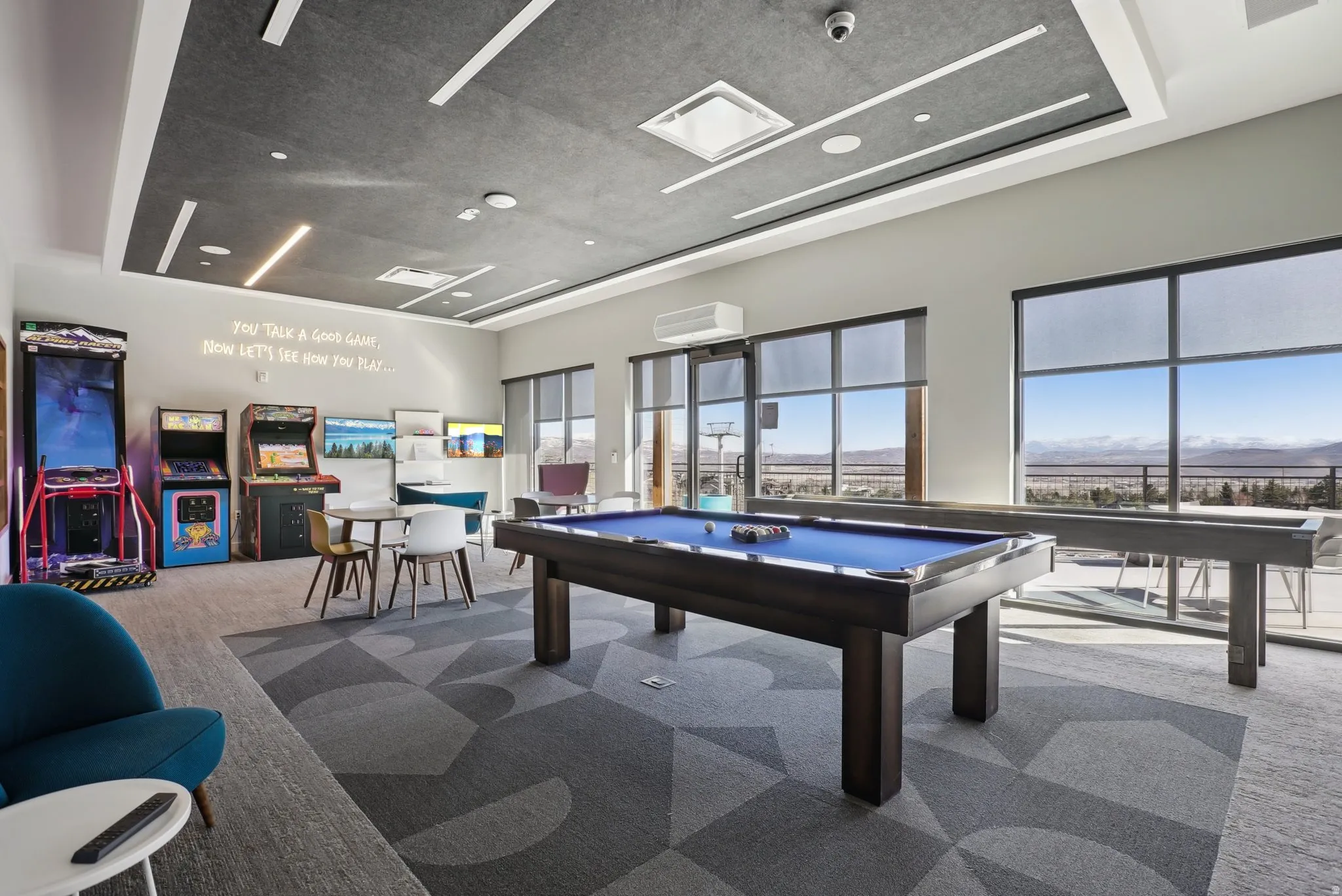 Recreational space featuring a pool table, shuffleboard, and arcade games