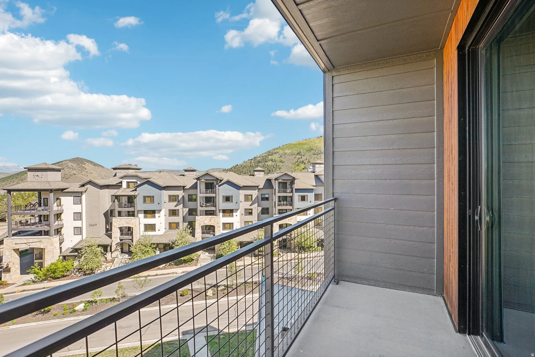 Private balcony with concrete flooring and dark metal railing