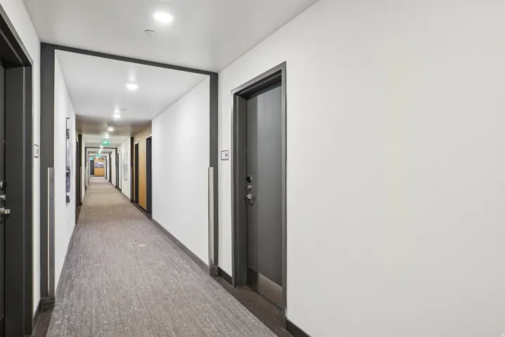 Building hallway featuring recessed lighting and wall-to-wall carpeting
