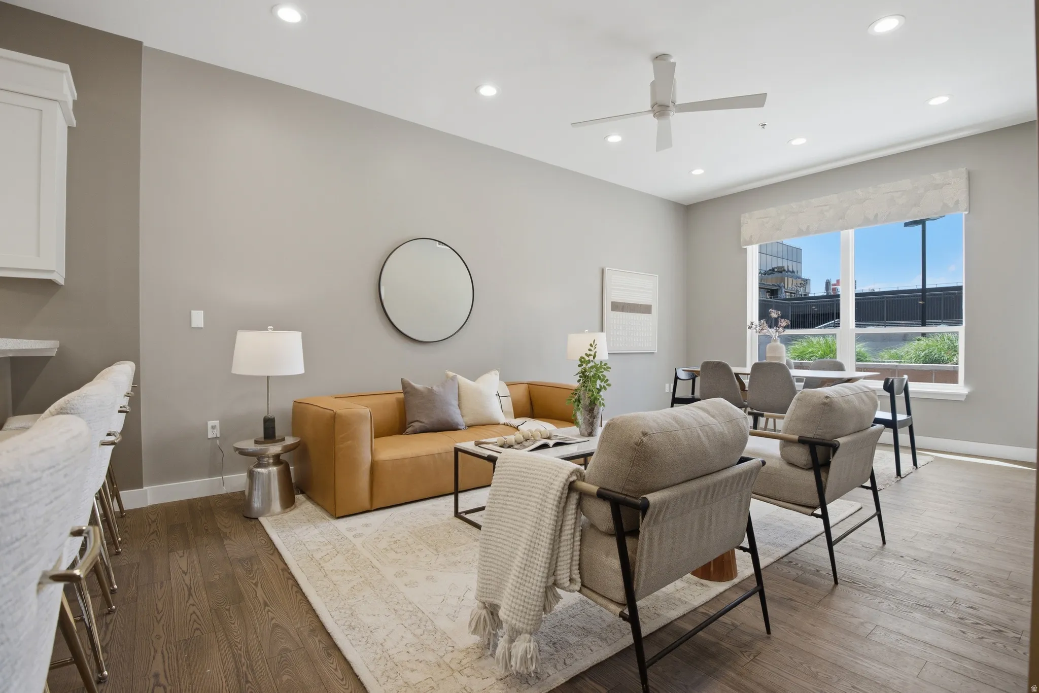 Open-concept living space featuring wood-finish flooring, recessed lighting, and a ceiling fan