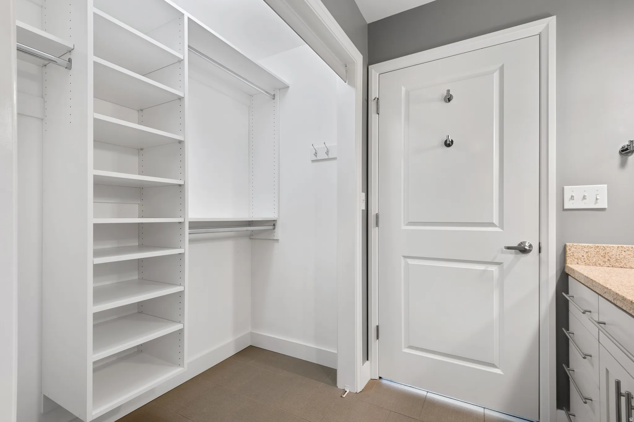 Custom closet system featuring white shelving and hanging rods