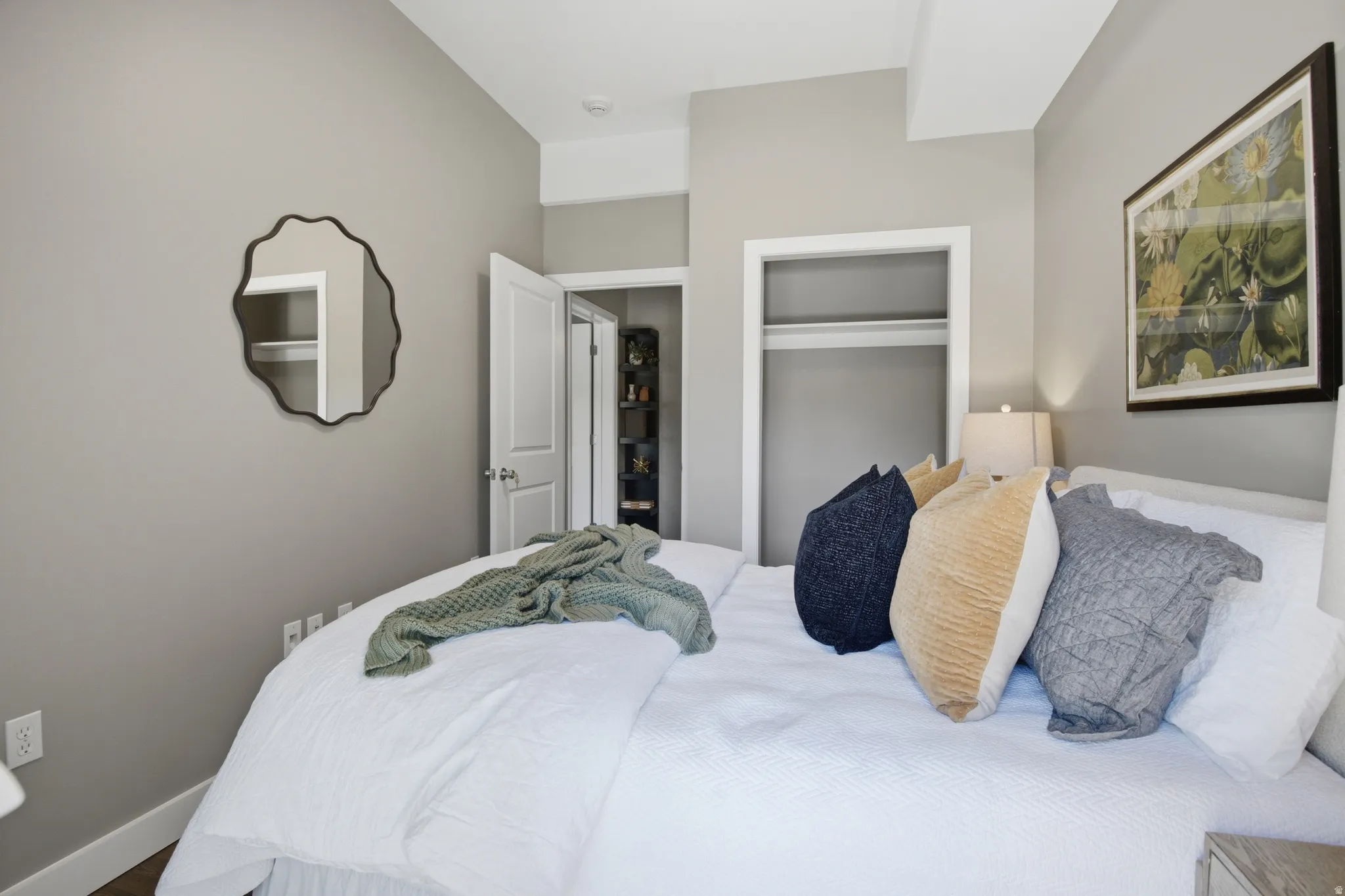 Bedroom featuring neutral wall color, recessed lighting, and a closet with shelving
