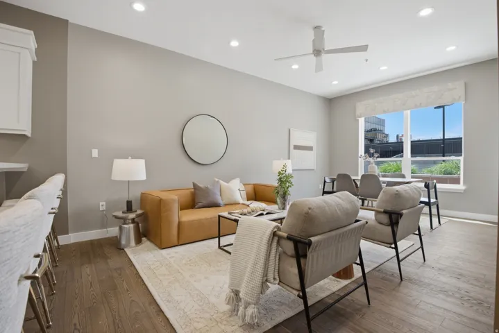 Open-concept living space featuring wood-finish flooring, recessed lighting, and a ceiling fan