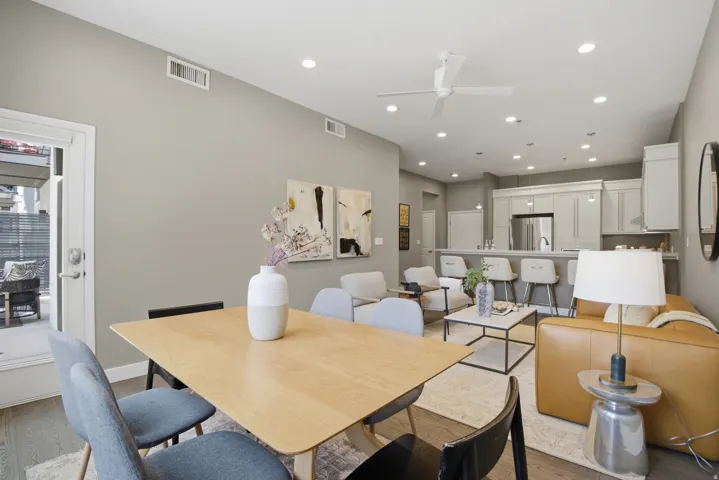 Open-concept living space with wood-finish flooring, recessed lighting, and a modern ceiling fan