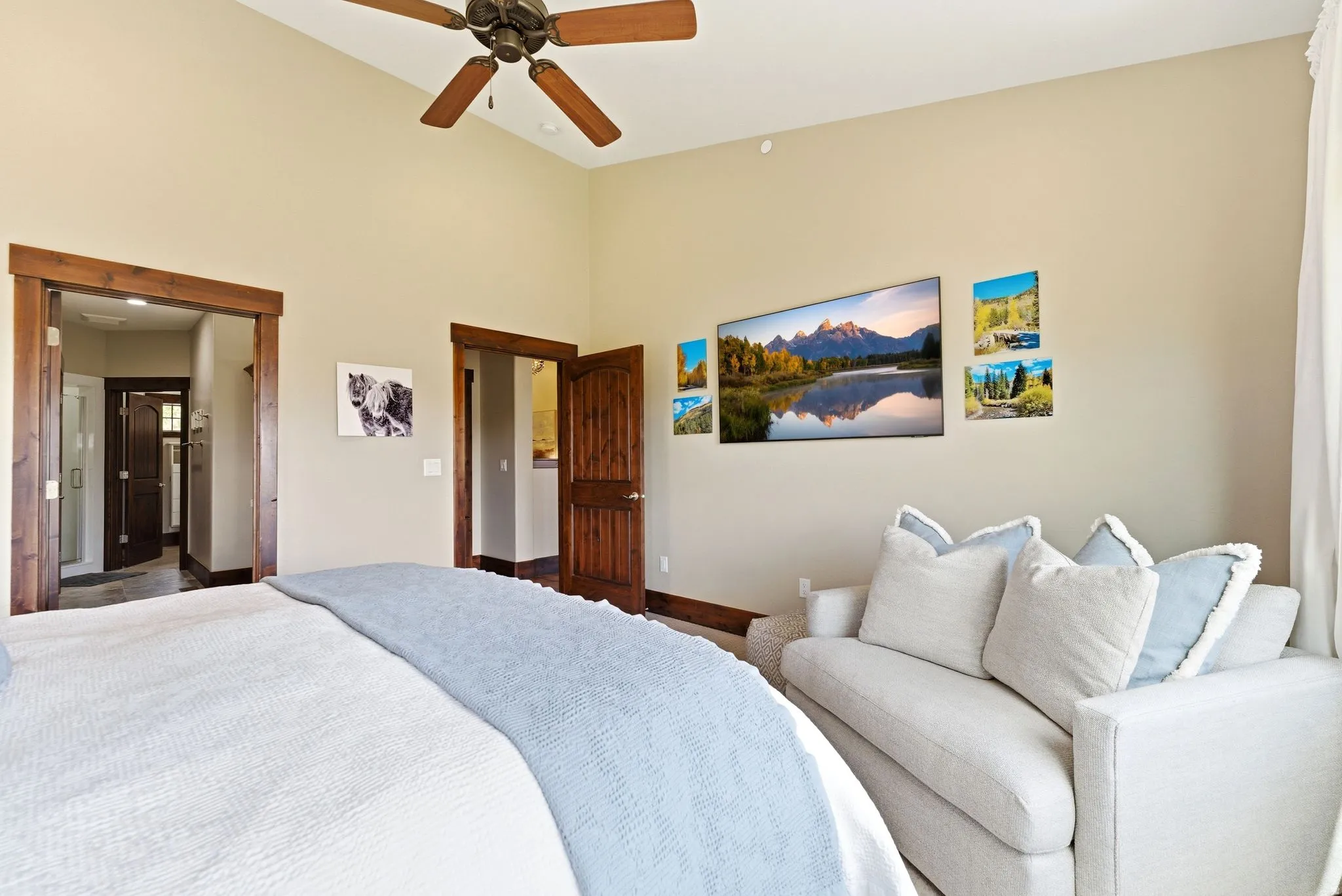 Vaulted ceilings with a ceiling fan, exposed wood trim, recessed lighting, and a built-in entertainment wall